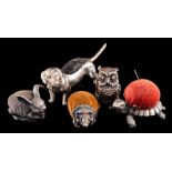 Five novelty metal pin cushions: in the form of an owl, turtle, hedgehog, hare and a dachshund (5).