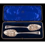 A pair of George III silver and later decorated Old English pattern berry spoons,