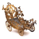 A 19th Century pressed metal and gilt decorated metal four wheeled carriage: the pierced foliate