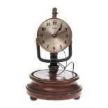 An early Bulle electric clock: the movement connected to a battery set within the base,