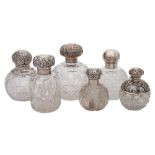 Six various clear cut glass and silver mounted scent bottles: various makers and dates,