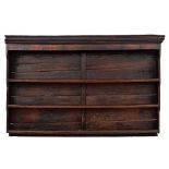An 18th Century oak dresser:, the associated shelved superstructure with a moulded cornice,