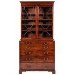 A George III mahogany secretaire bookcase:, the upper part with a moulded dentil cornice,