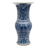 A Chinese blue and white beaker vase: of Gu form painted with shou symbols on a scrolling peony