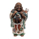 A Japanese Imari porcelain figure: of a laughing Hotei carrying a child on his back and wearing