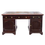 An Edwardian mahogany pedestal desk:, the rectangular top with a moulded edge,