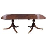 A mahogany twin pillar dining table in the Regency taste:,