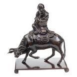 A late 17th/early 18th Century Chinese bronze figure of Lao-Tze: dressed in robes and riding on an