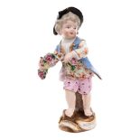 A small Meissen figure of a boy holding a garland: on rocaille moulded tree stump base,