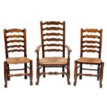 A harlequin set of eight early 19th Century oak, elm and ash ladder back dining chairs:,