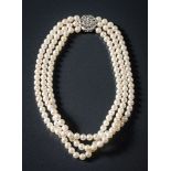 A cultured pearl three-string necklace: the cultured pearls measure an average of 6.