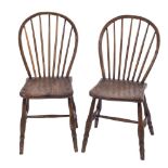 Two early 19th Century 'Yealmpton' ash stick back kitchen chairs:, having shaped solid seats,