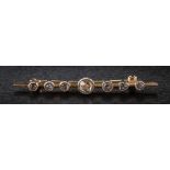 A rose diamond mounted bar brooch: with seven graduated stones to include a heart-shaped rose