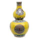 A Chinese famille jeune double gourd vase: painted with Shou and bird medallions between wave,