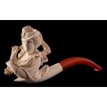 A late 19th Century carved Meerschaum pipe: the bowl in the form of an elegant woman wearing a