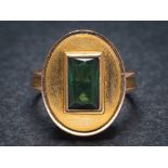 A green tourmaline mounted single-stone dress ring: with central rectangular green tourmaline,