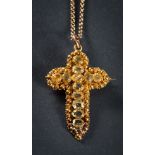 A Cannetille gold and chrysolite pendant cross: approximately 42mm long, with attached gold chain.