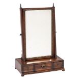 A George III mahogany swing frame platform toilet mirror: the bevelled plate within a gilt foliate