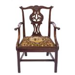 A George III carved mahogany elbow chair:, in the Chippendale taste,