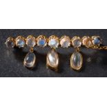 A moonstone mounted bar brooch: set with a single row of circular moonstones,