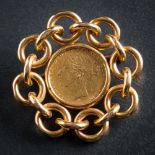 A Victorian sovereign dated 1873 mounted as a brooch: within a circular-link chain design frame