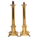 A pair of 20th Century brass column table lamps: of plain form raised on square bases with lion paw