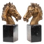 A pair of cast brass bookends: in the form of a horse's head,