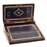 A 19th century rosewood and brass bound campaign writing box: the hinged lid enclosing fitted pen