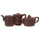 Two Chinese Yixing stoneware teapots: one of mid brown hue of squat and banded cylinder form with