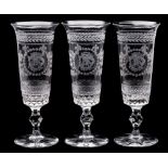 A set of nine etched glass flutes: the mildly flaring bowls engraved with the initials K.S.D.
