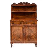 A William IV mahogany chiffonier: the graduated two tier shelved superstructure with panel backs