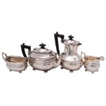 A George V silver four- piece tea service, maker Harrods, Birmingham, 1935: of barge-shaped outline,