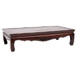 A Chinese lacquered rectangular low table:, having a shaped apron on curved legs,