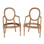 A matched pair of Louis XVI carved beechwood fauteuil frames:, with oval backs,