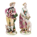 A pair of Chelsea-Derby figures of a shepherd and shepherdess: she wearing a green bodice and