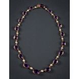 An early 20th Century gold, amethyst and seed-pearl necklace: with graduated,