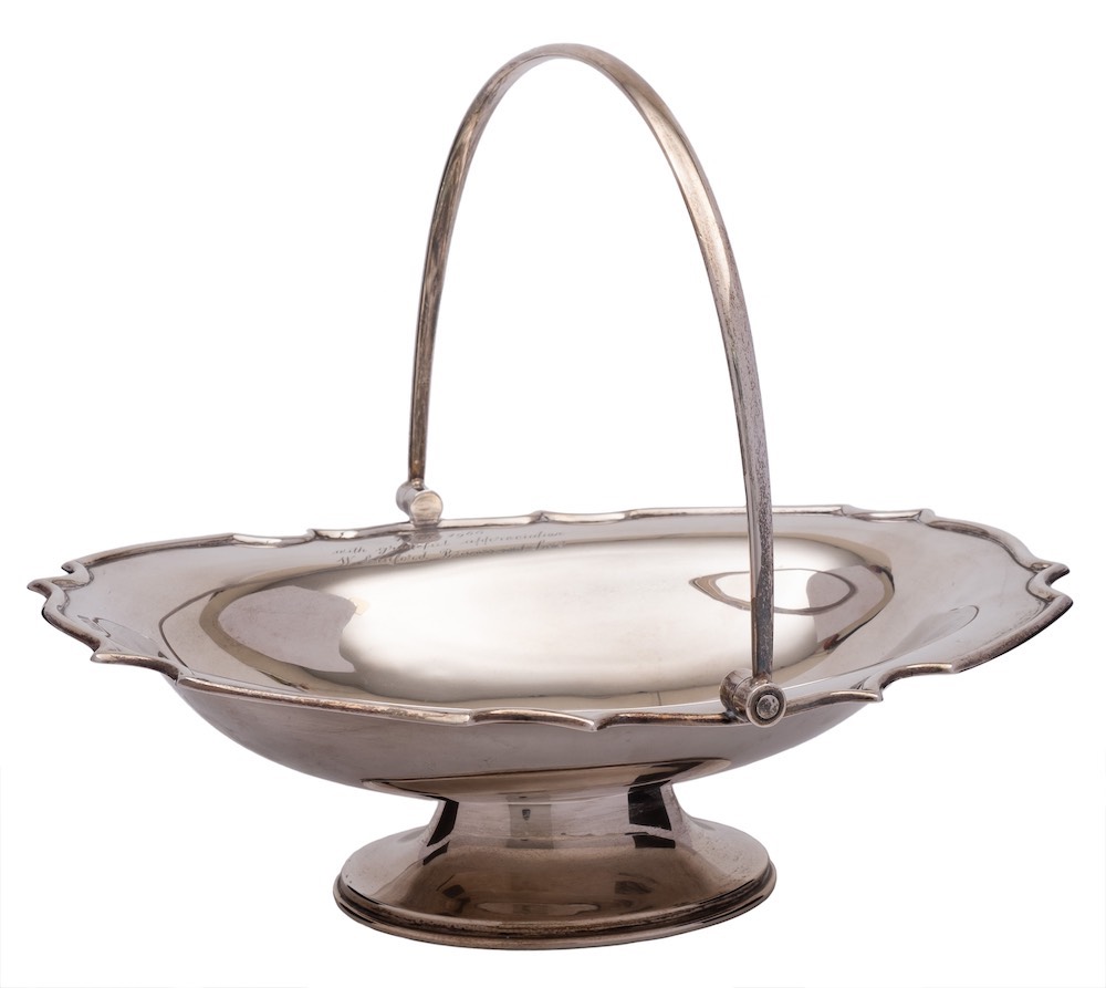 An Edward VII silver pedestal swing-handled basket, maker Barker Brothers, Chester,