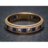 A blue and white spinel mounted eternity ring: stamped '18ct', approximately 4gms gross weight,