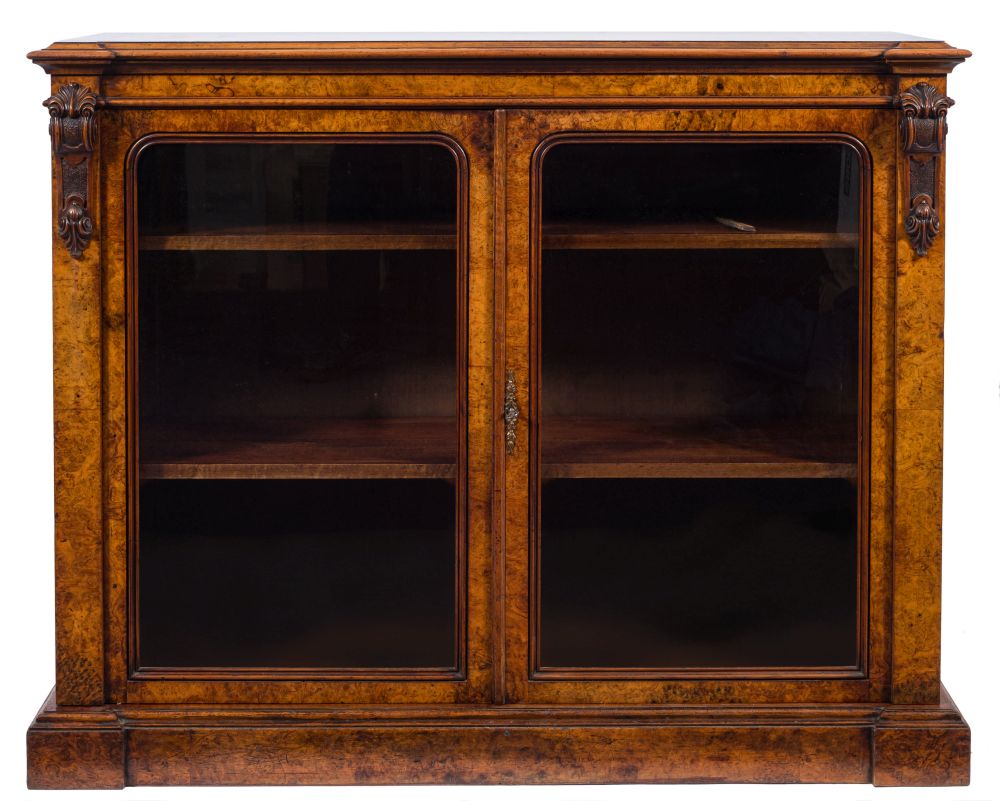 A Victorian burr walnut low bookcase:, of recessed breakfront outline, the top with a moulded edge,