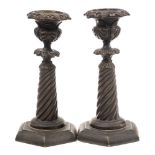 A pair of French Restauration bronze candlesticks: with spiral reeded columns and hexagonal bases,