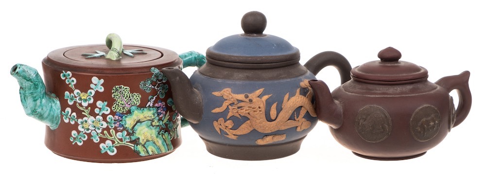 Three Chinese Yixing stoneware teapots: of various hues comprising a banded cylindrical example