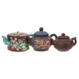 Three Chinese Yixing stoneware teapots: of various hues comprising a banded cylindrical example