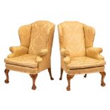 A pair of carved beechwood wing frame armchairs:, in the early 18th Century taste,