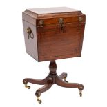 A Regency mahogany and inlaid teapoy of sarcophagus shape:, bordered with ebony lines,