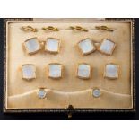 A cased set of mother-of-pearl mounted cuff-links and dress studs: stamped '9ct'.