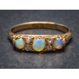 An 18ct gold, opal and diamond seven-stone ring: Chester assay marks to shank, ring size K 1/2.