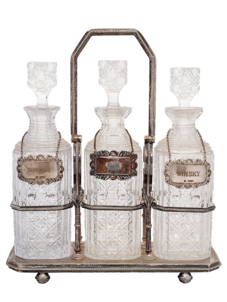 A Victorian silver plated three-division tantalus: inscribed,