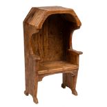A child's 19th Century pine settle:, with a canted overhanging canopy, shaped arms and solid seat,