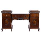 A 1920's carved mahogany dining suite in the George II taste:,