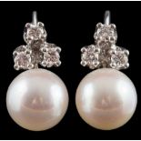 A pair of cultured pearl and diamond ear studs: each set with a single cultured pearl approximately
